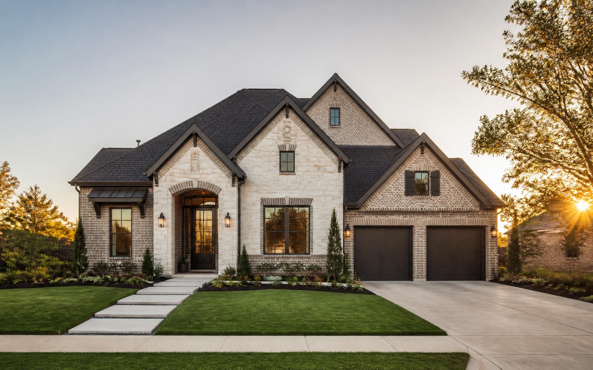 Texas brick and stone home with a new dark shingle roof at golden hour